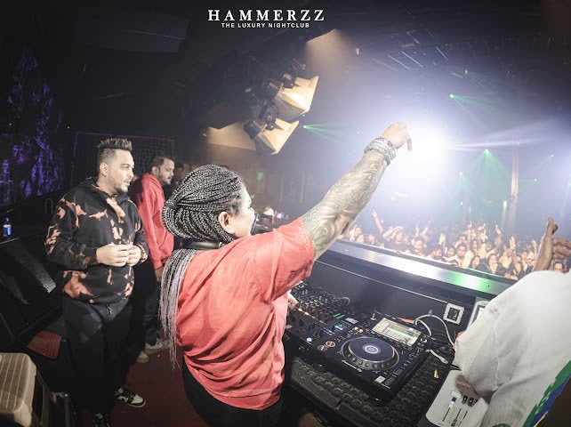 DJ Kim with one hand raised at Hammerzz, Goa