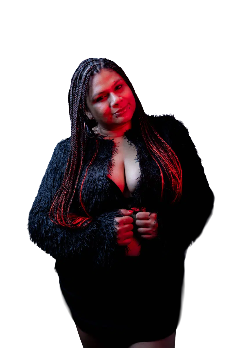 DJ Kim in a black outfit with red studio light across her braids