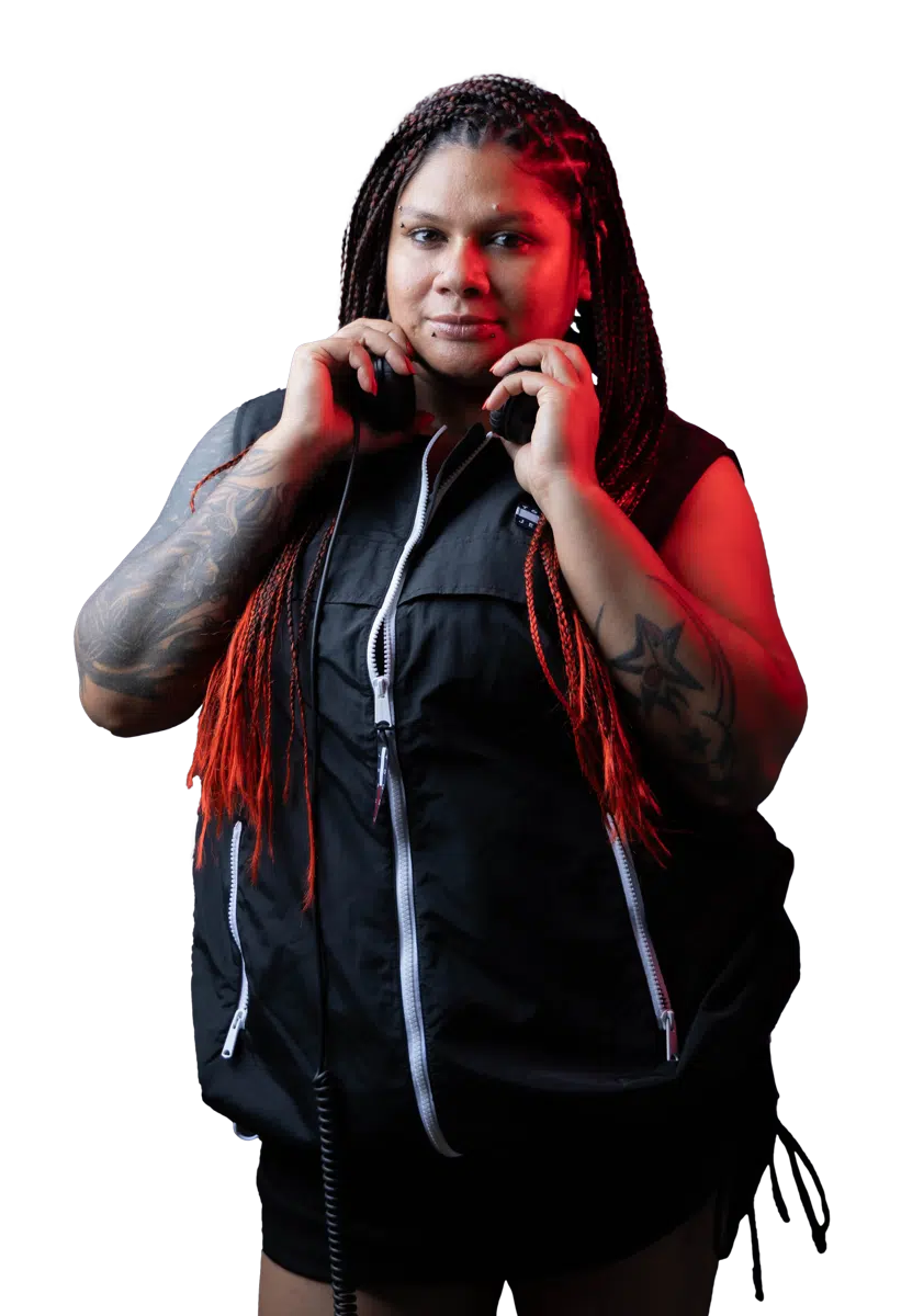 DJ Kim holding headphones around her neck in the studio