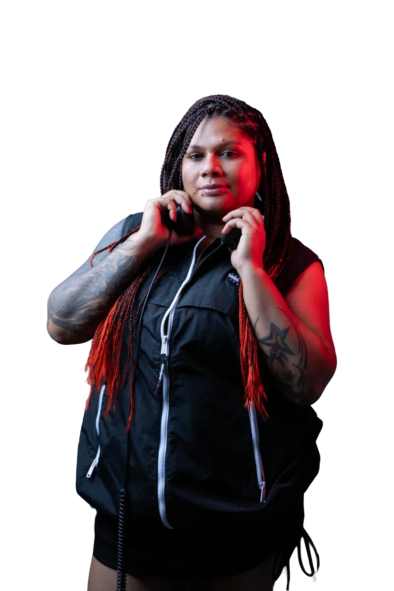 DJ Kim holding her headphones and looking into the camera